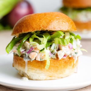 A toasted brioche bun with creamy shrimp salad and shredded romaine lettuce.