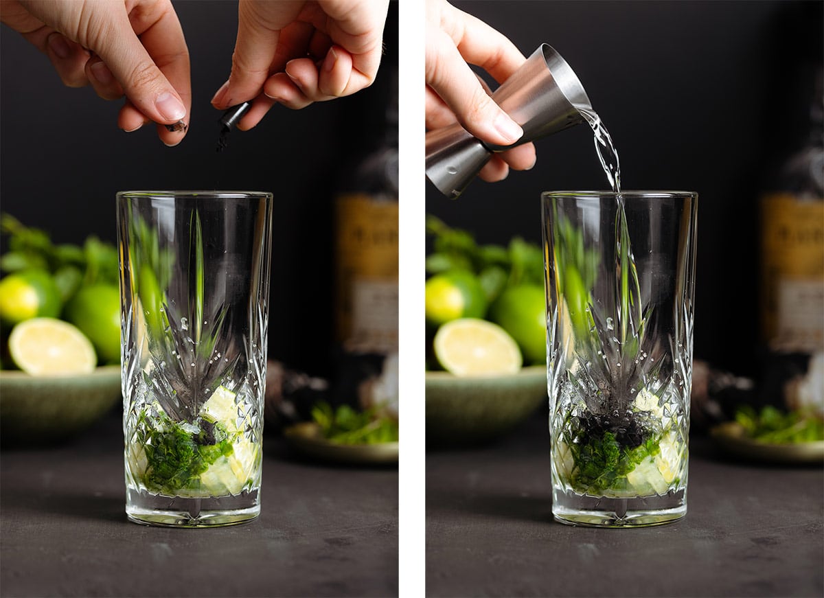 A charcoal capsule being emptied into a tall glass with mint, lime, and white rum.