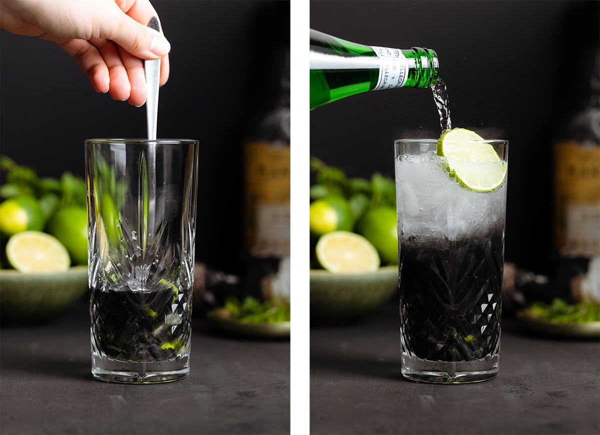 A hand stirring mojito ingredients with activated charcoal in a tall glass and adding sparkling water.