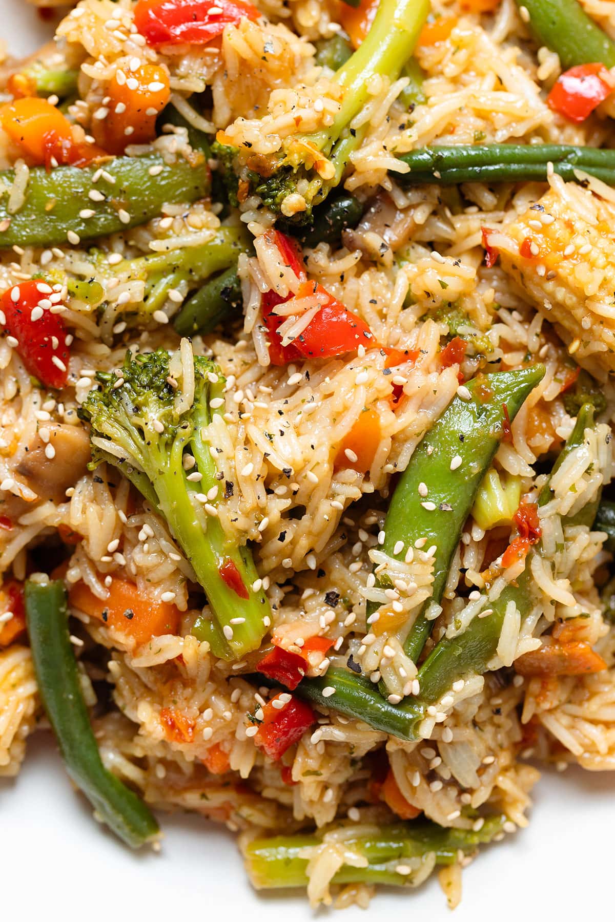 Rice stir fry with mixed thai style frozen vegetables sprinkled with black pepper.