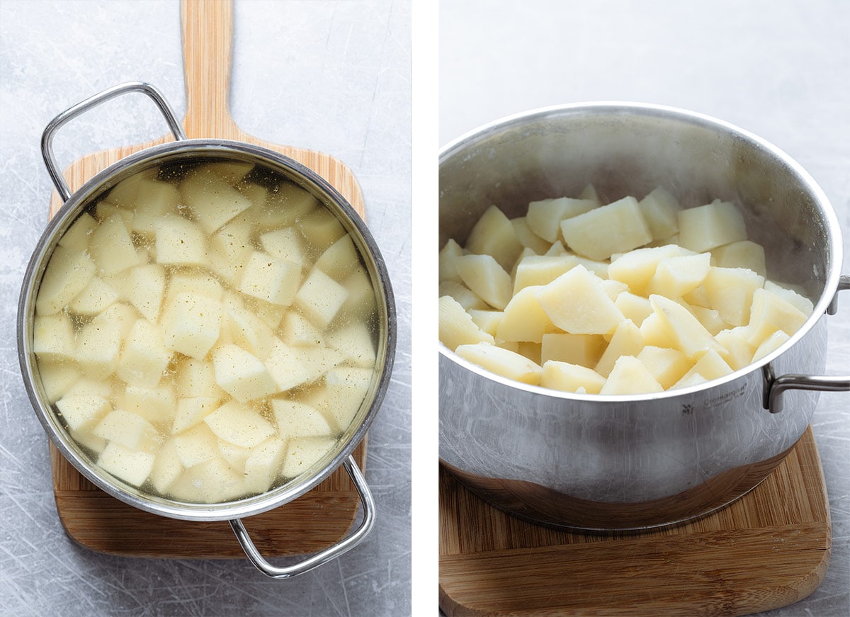 Peeled and chopped yellow potatoes being cooked in a large pot.