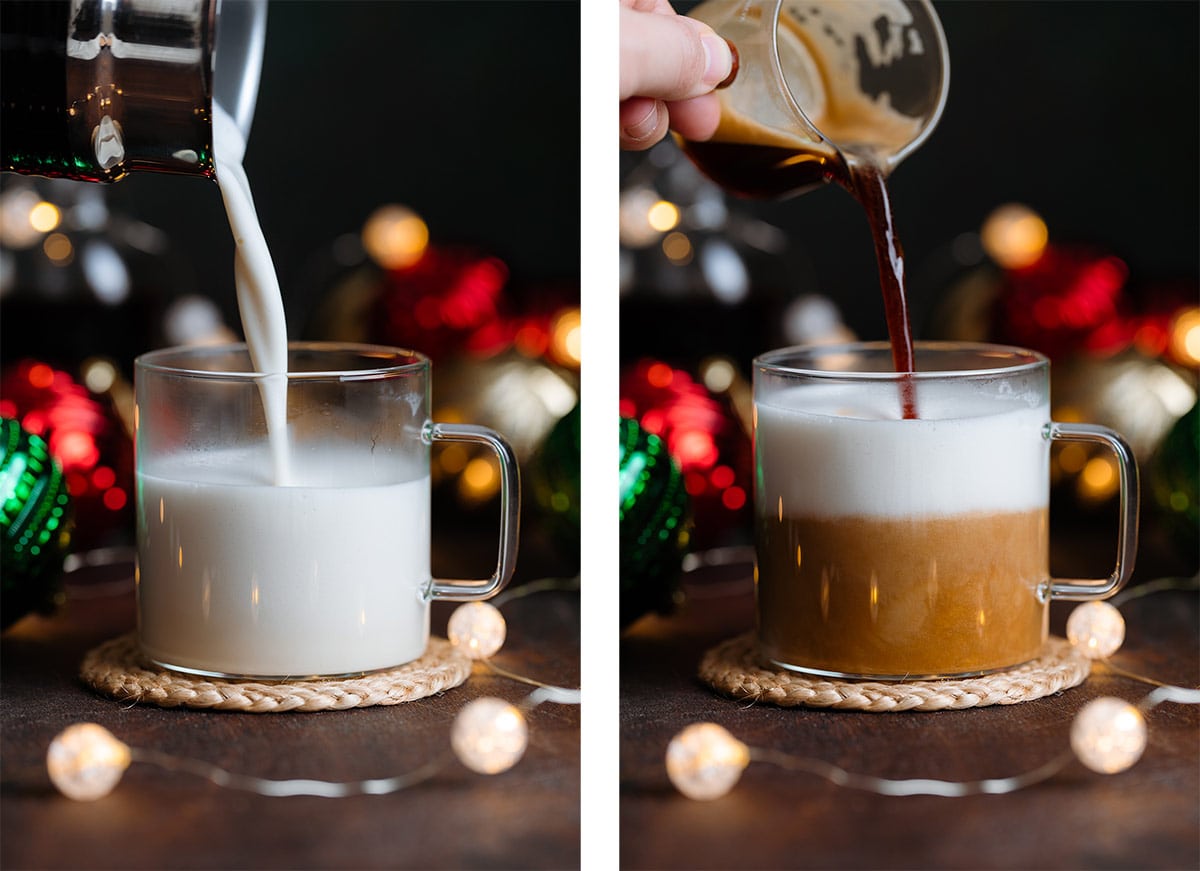 Frothy milk and espresso being poured into a glass cup on a dark wooden background.