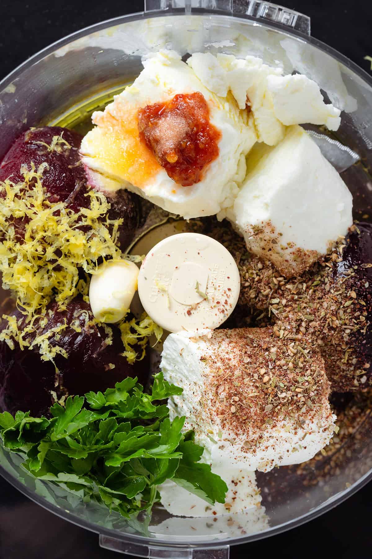 Cooked beets, soft goat cheese, spices, and fresh parsley in a food processor.