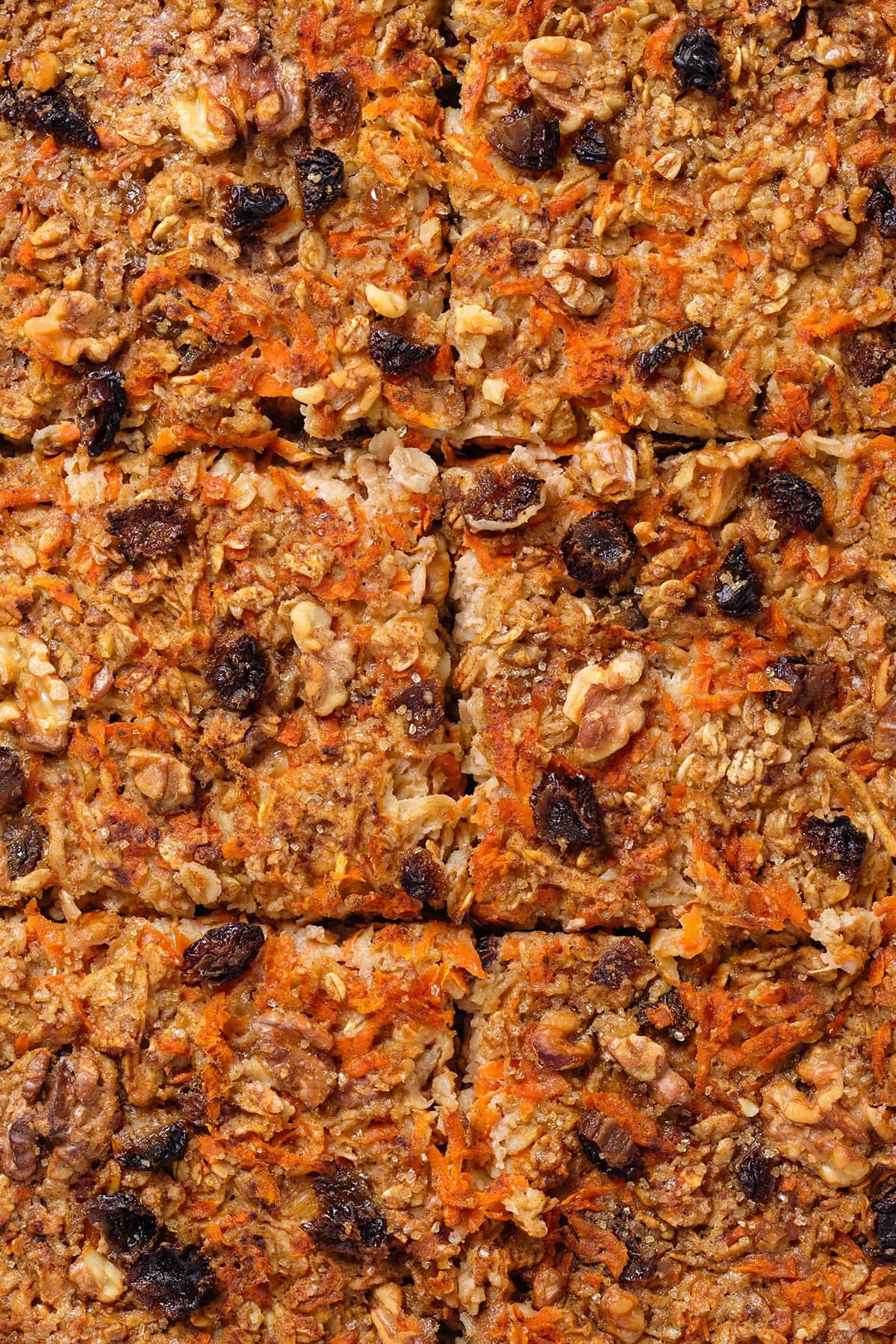 Carrot cake baked oatmeal sliced into six pieces showing crispy texture on top after baking.