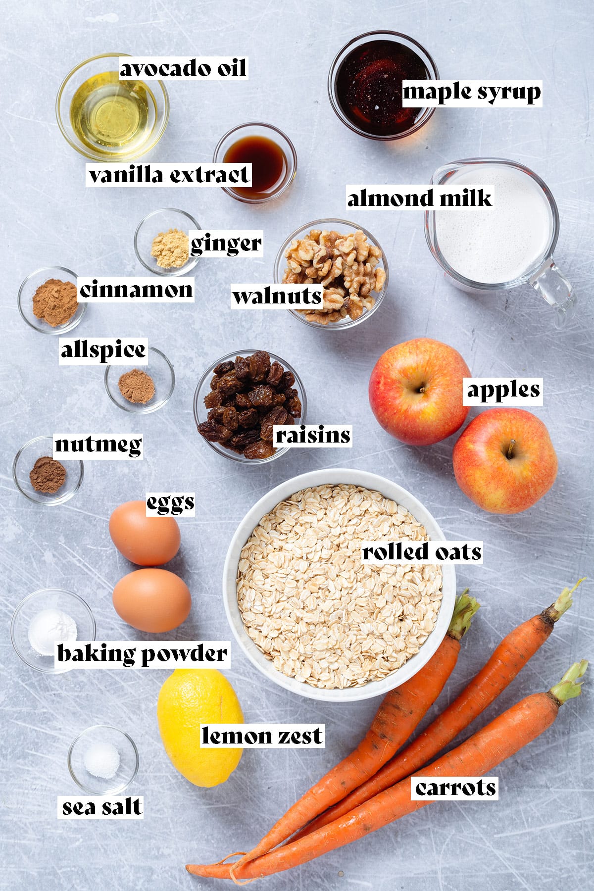 Ingredients for baked oatmeal laid out on a grey background.
