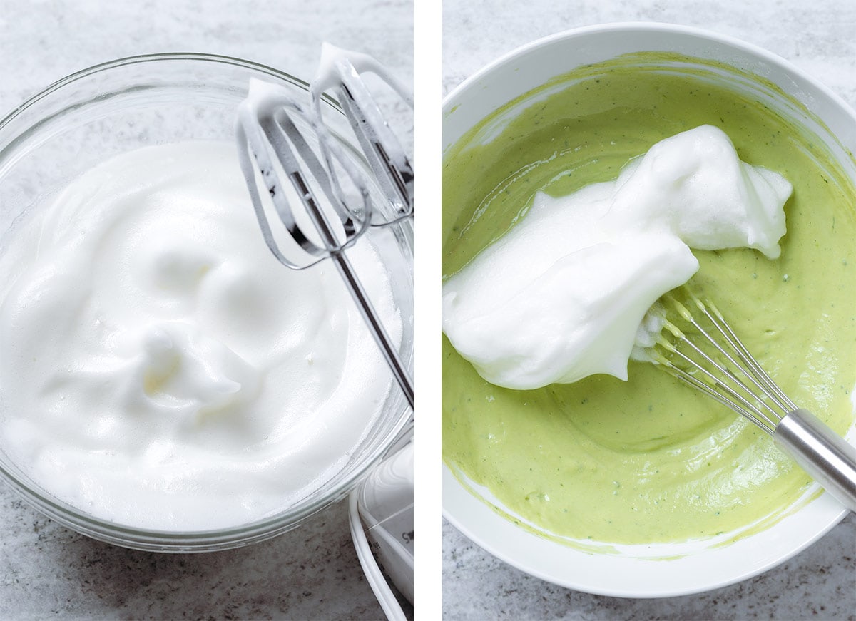 Whipped egg whites in a large glass bowl and them being added to green pancake batter.
