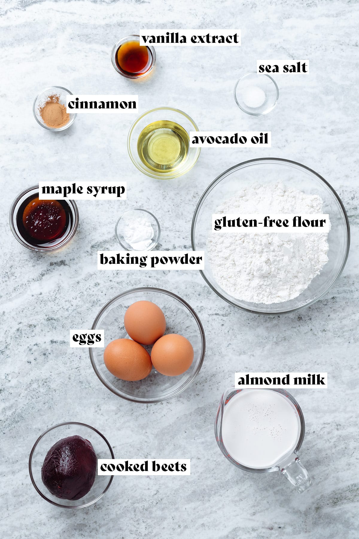 Flour, eggs, milk, a cooked beet, and other ingredients laid out on a stone background with text overlay explaining the ingredients.