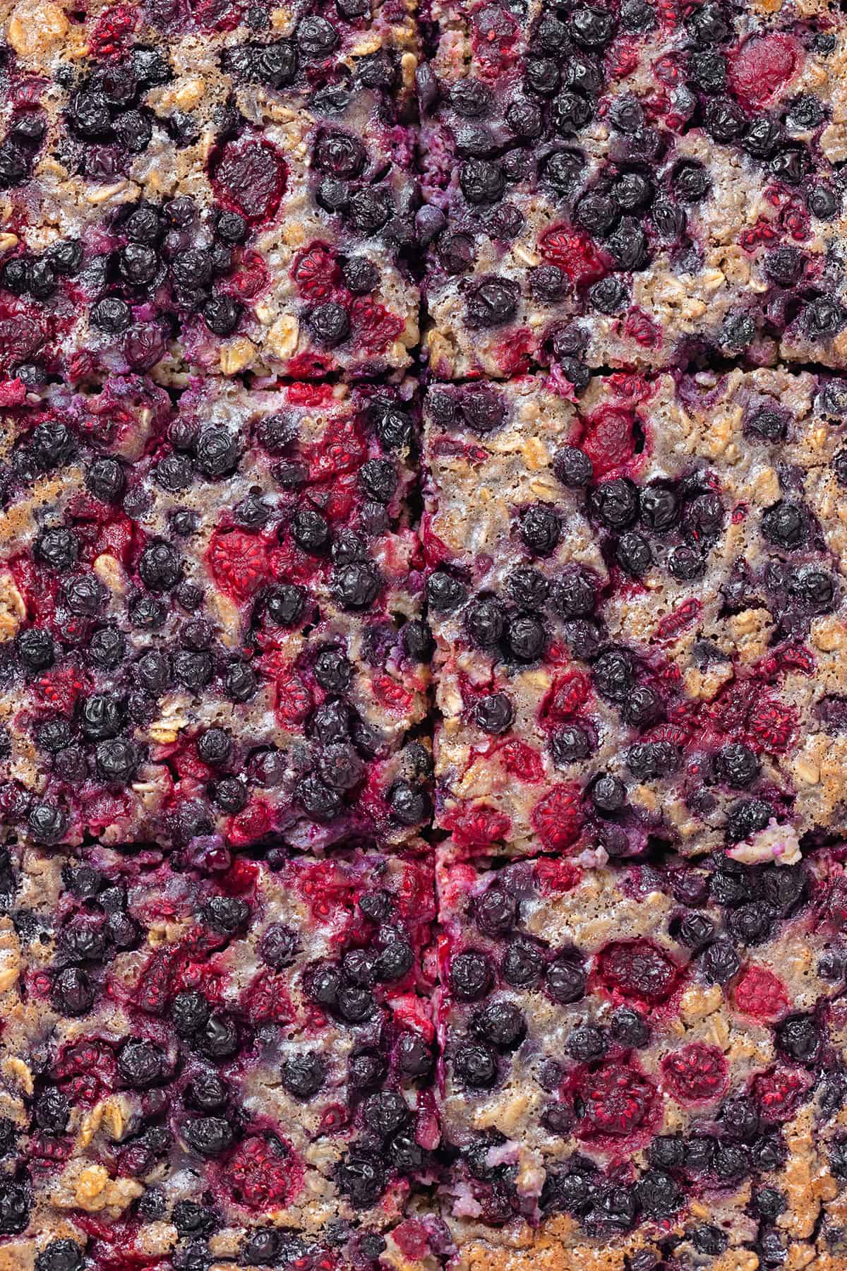 Close up of baked blueberry oatmeal cut into six slices.