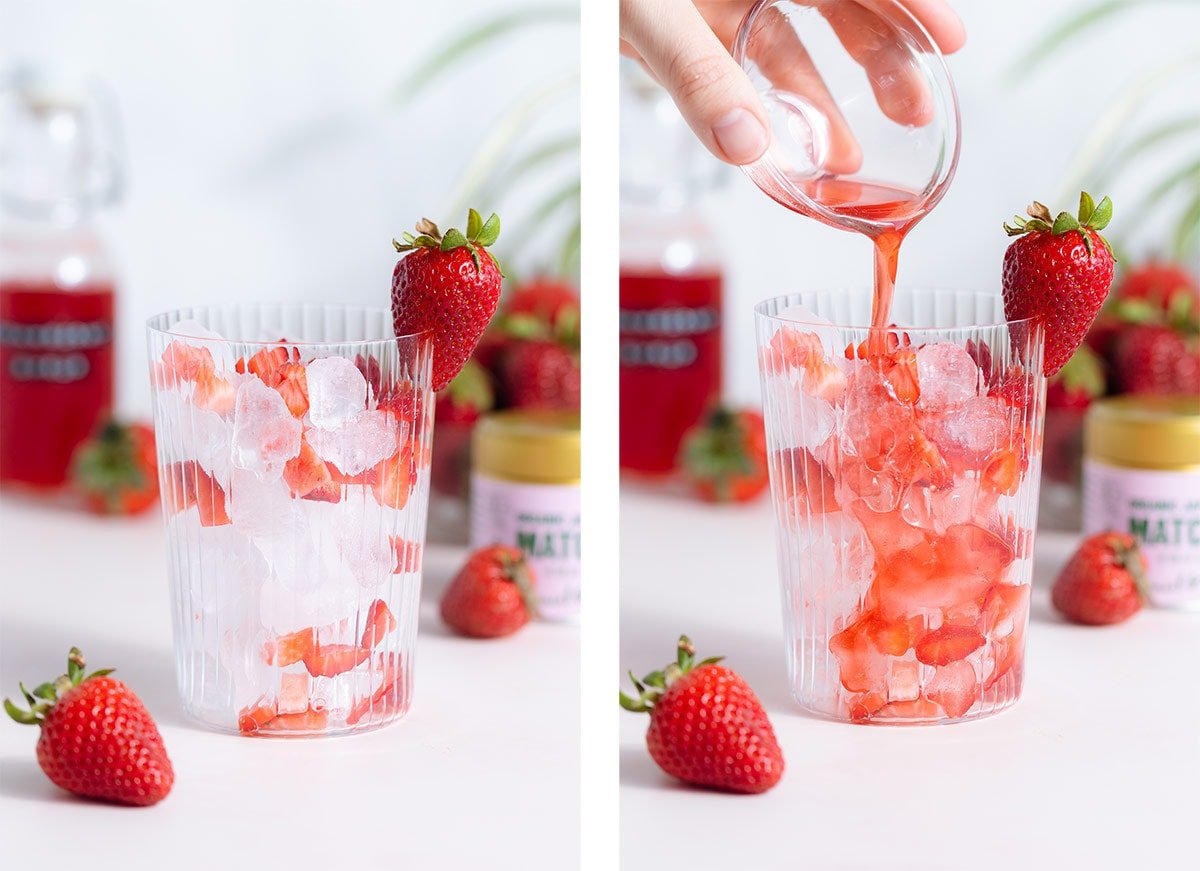 Strawberry syrup being poured into a tall glass over ice and chopped strawberries.