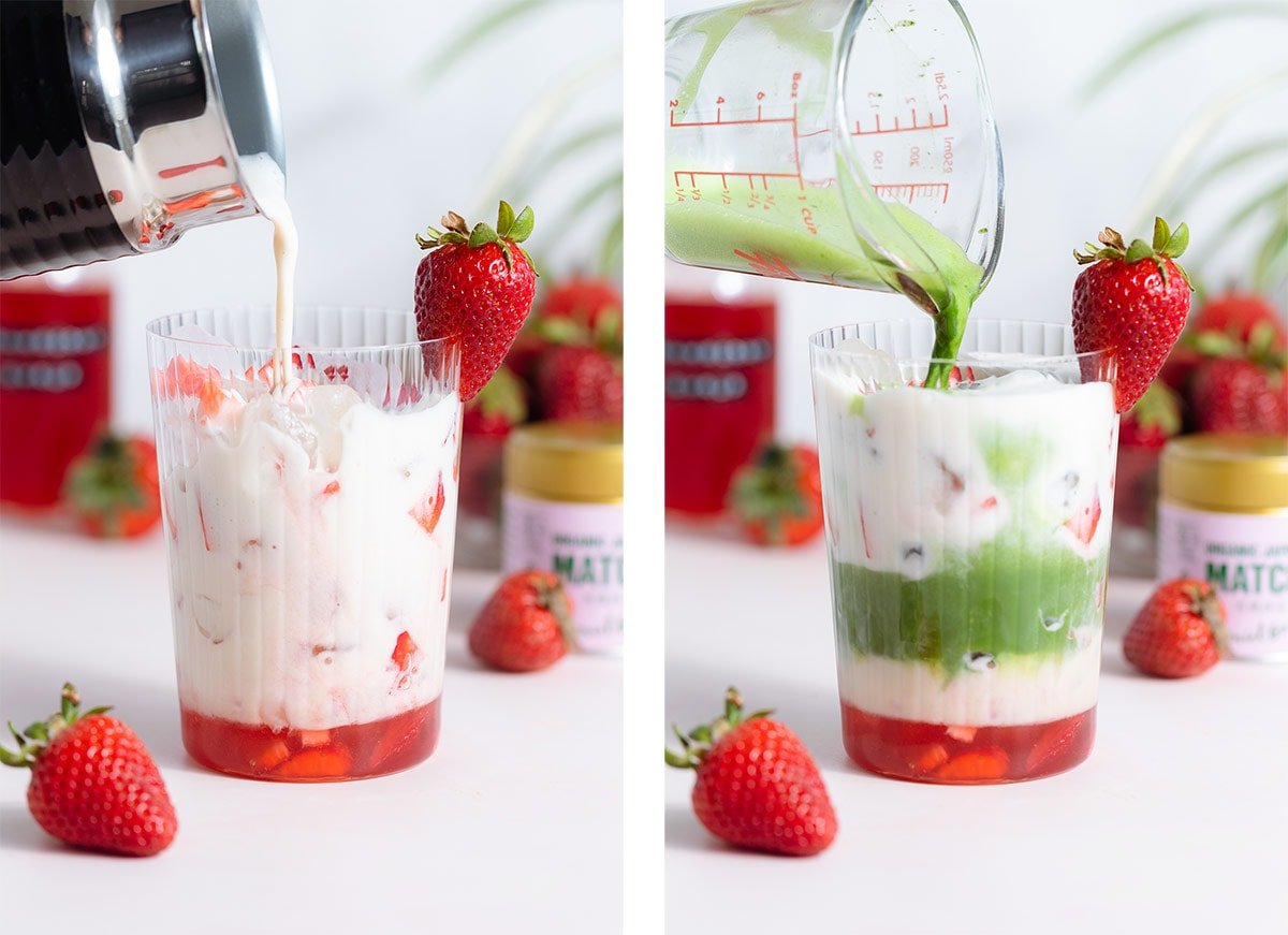 Milk and matcha being poured into a tall glass with strawberry syrup over ice.