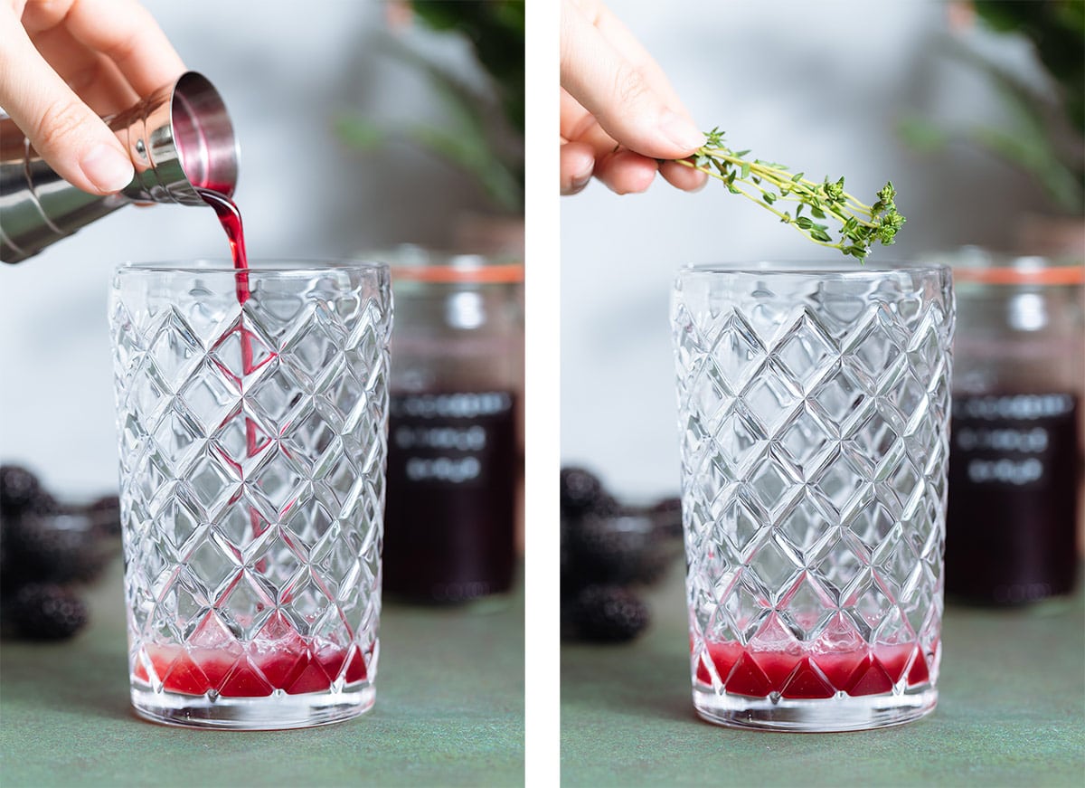 Blackberry syrup and fresh thyme being added into a glass cocktail shaker.