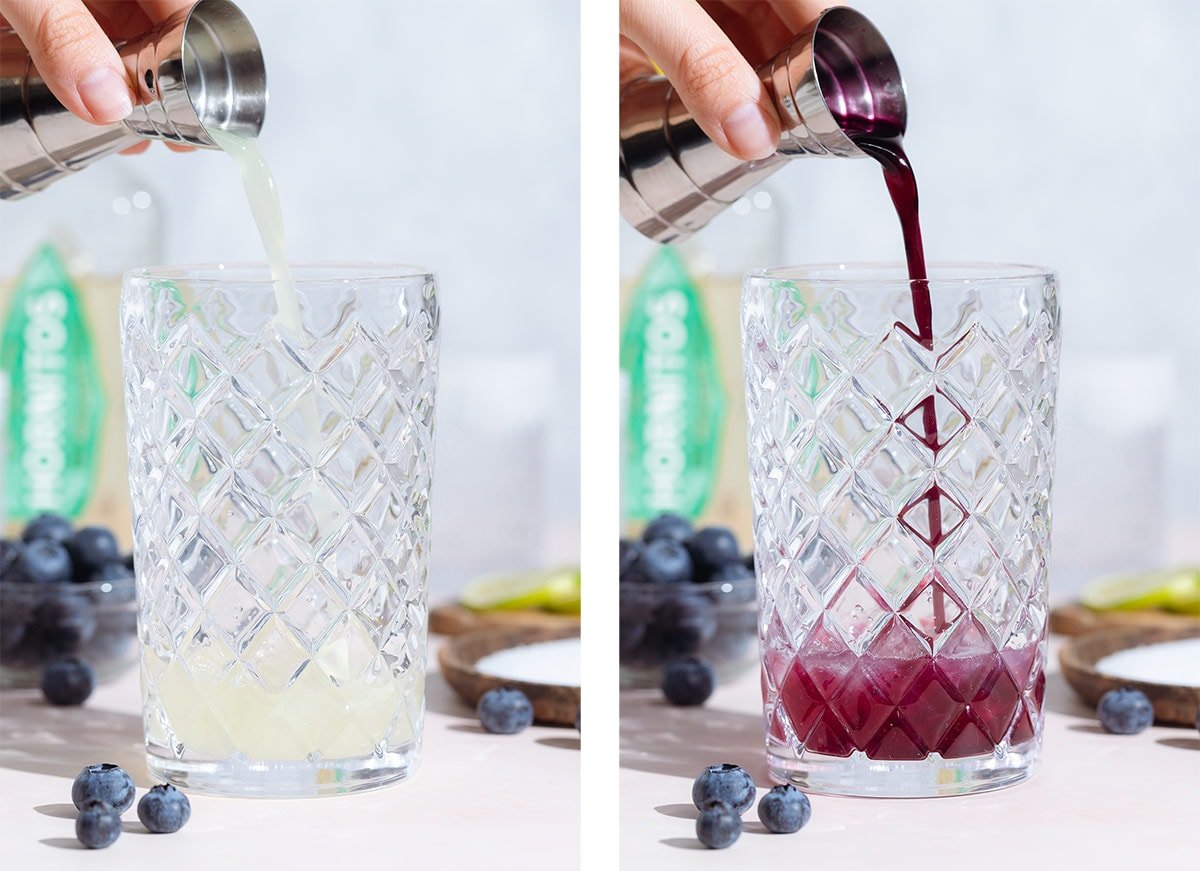 Lime juice and purple blueberry syrup being poured into a glass cocktail shaker.