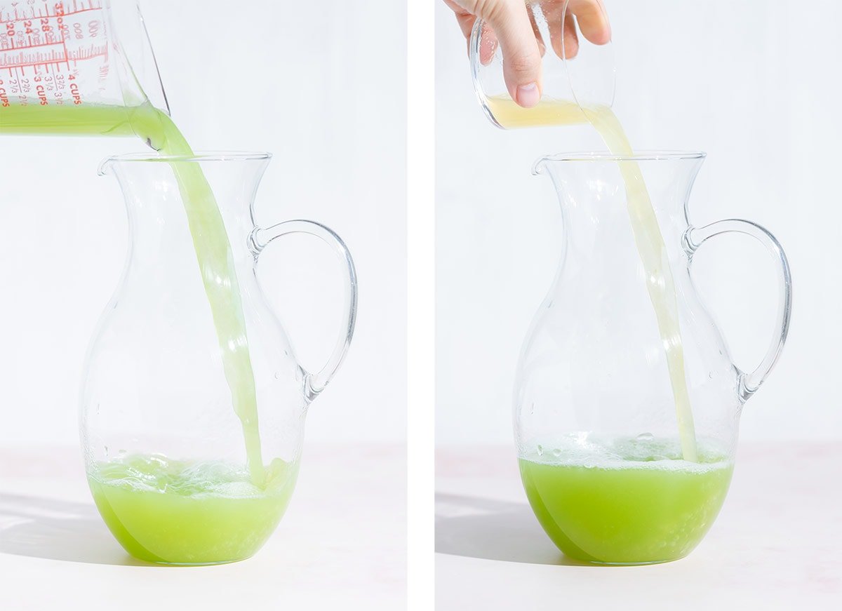 Cucumber and lemon juice being poured into a tall glass jug.