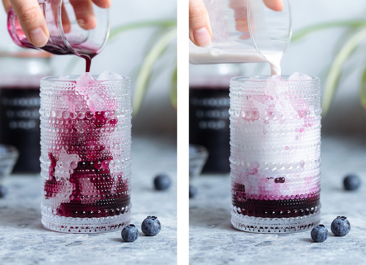 Blueberry syrup and milk being poured into a tall glass over ice.