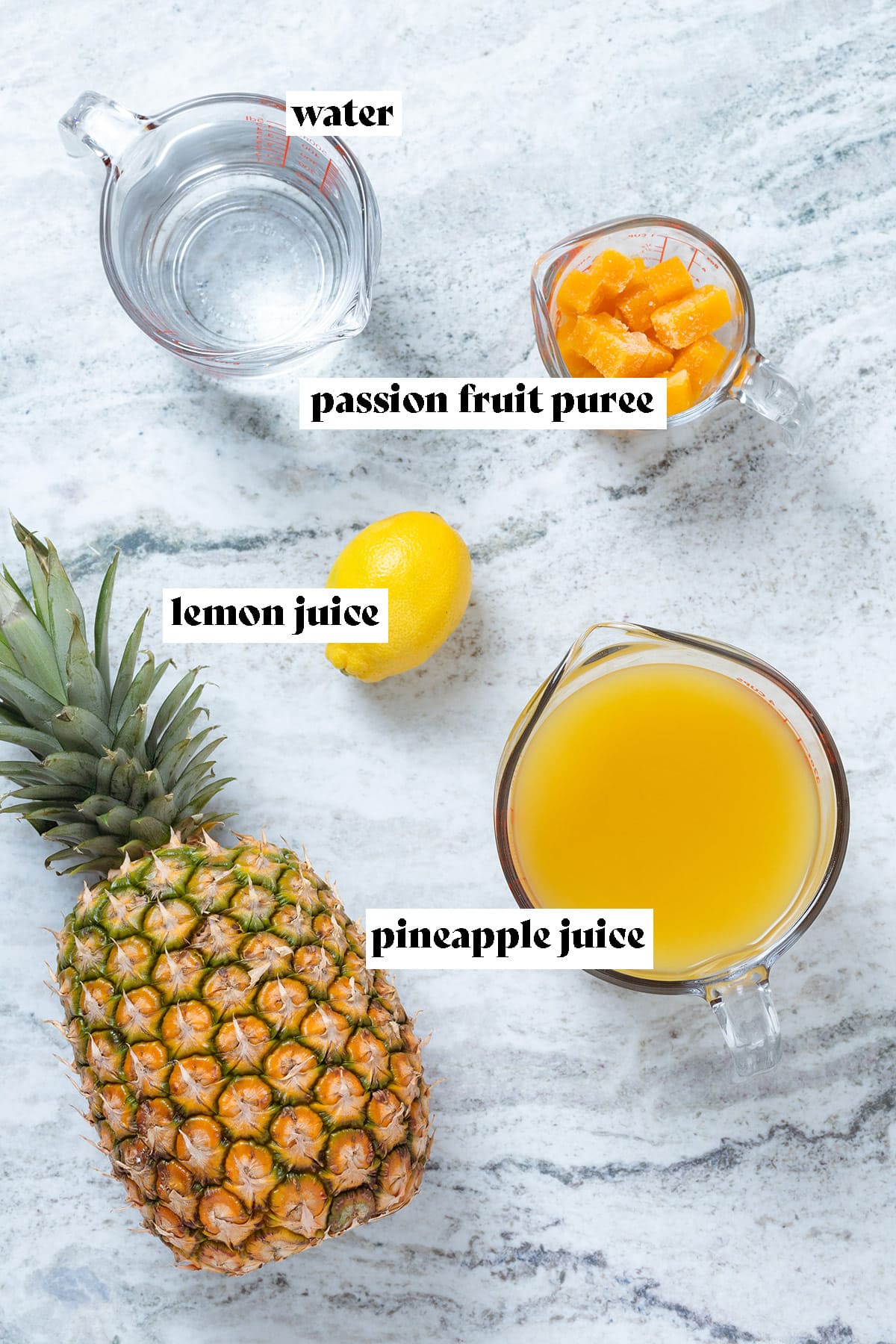 Ingredients like pineapple juice, lemon, and passion fruit puree laid out on a stone background with text overlay.