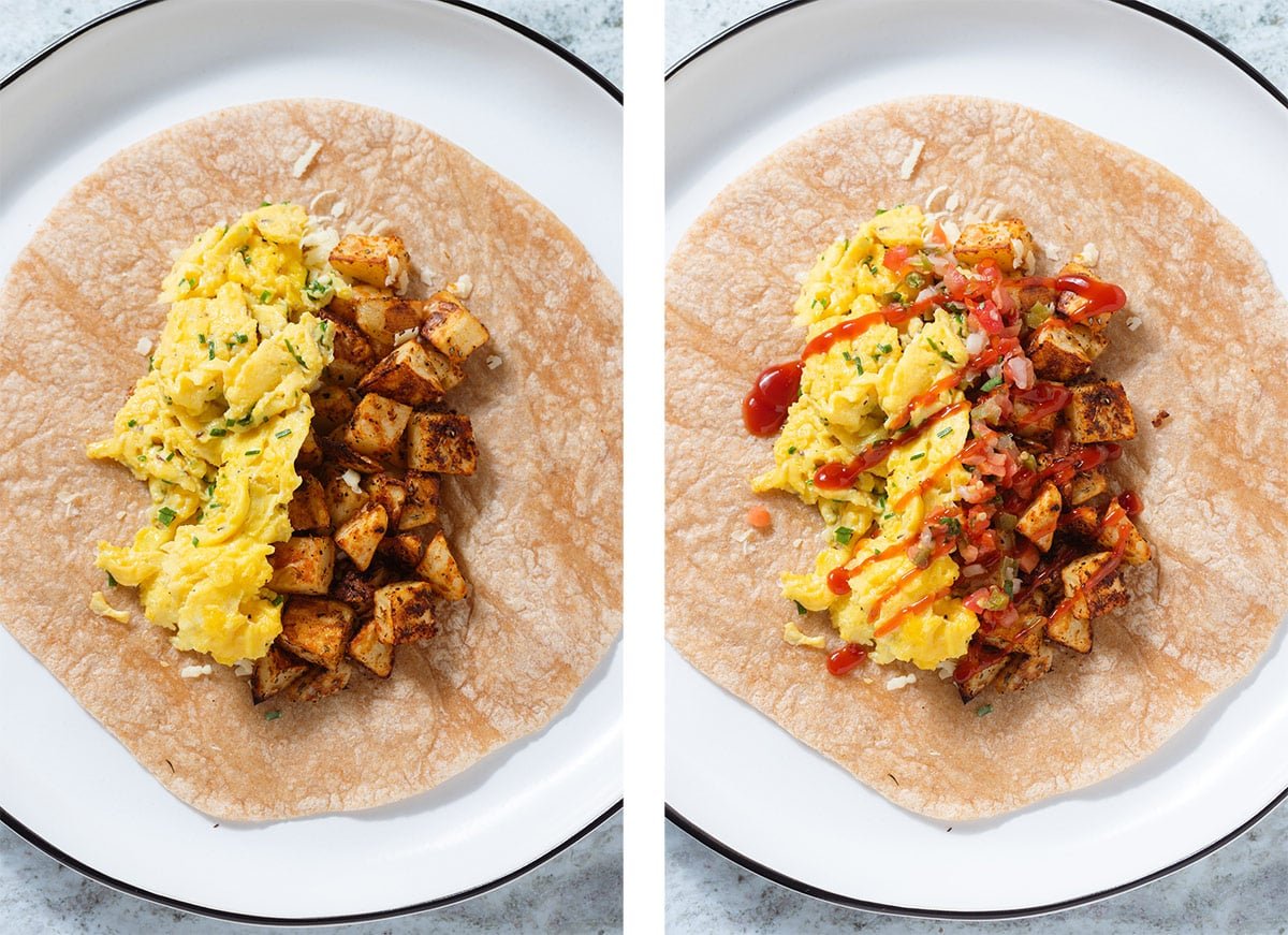 A large tortilla on a white plate with scrambled eggs, roasted potatoes, pico de gallo, and ketchup.