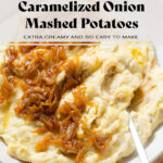 Mashed potatoes topped with caramelized onions in a white bowl on a wooden plate.