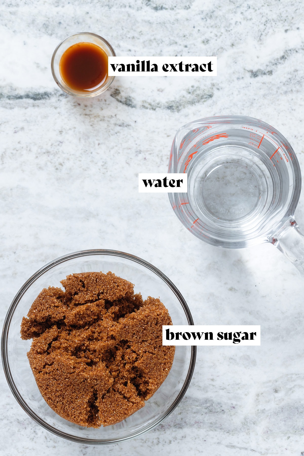 Brown sugar, water, and vanilla extract in glass bowls all measured out with text overlay.