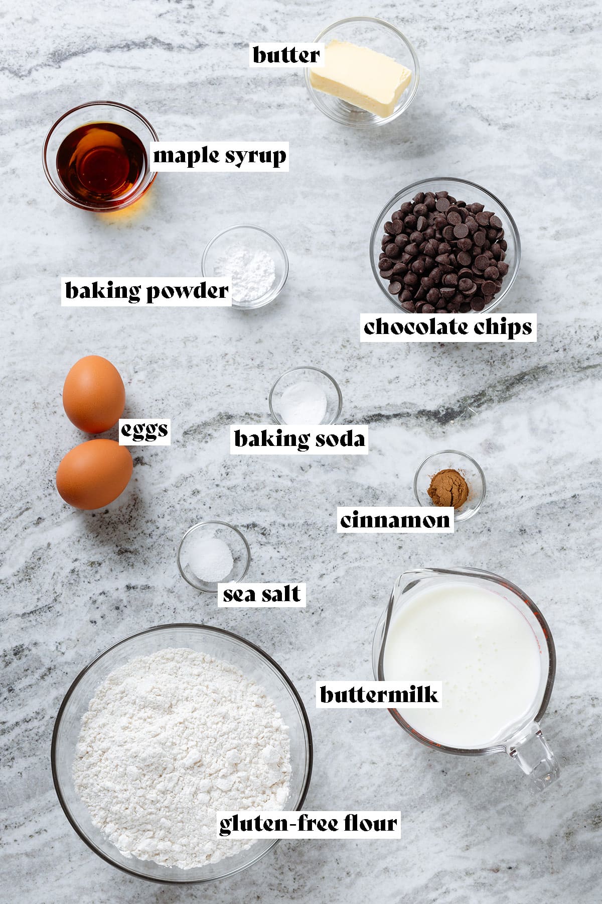 Flour, eggs, buttermilk, chocolate chips, maple syrup, butter, and other ingredients all measured and laid out with text overlay.
