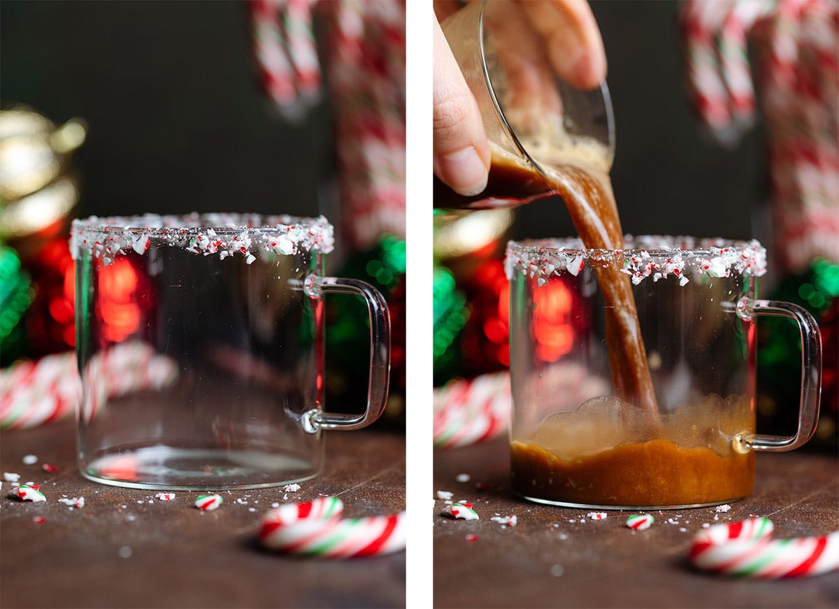 A glass mug garnished with crushed candy canes on a glass rim and a shot of espresso being poured in.