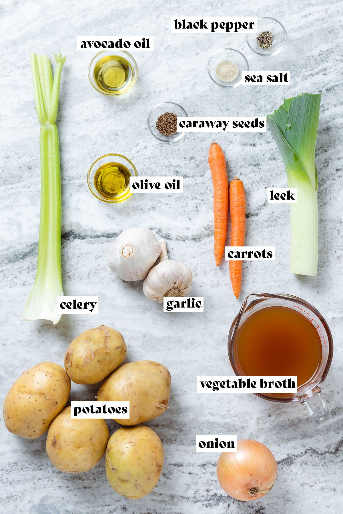 Potatoes, celery, carrots, vegetable broth, and other ingredients laid out on a stone background with text overlay.