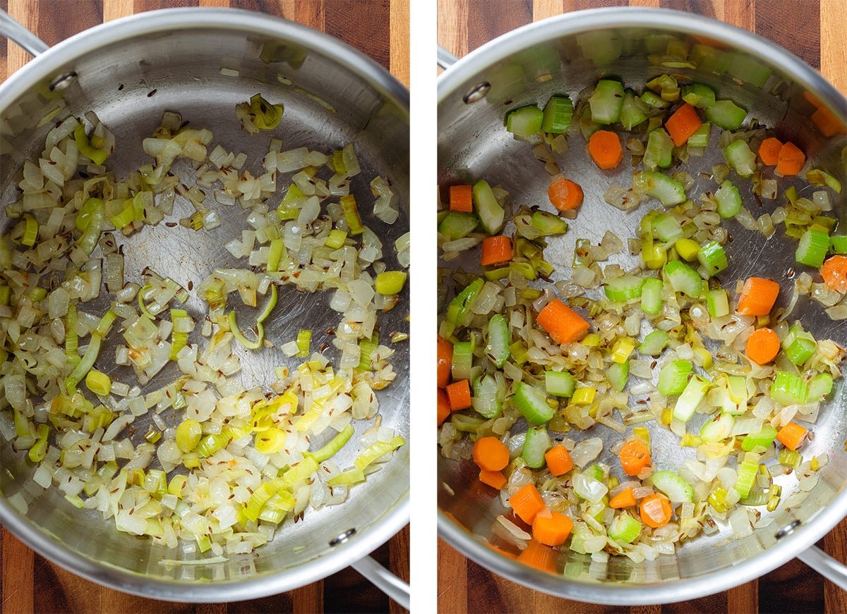 A large pot with sauteed onion, carrot, and celery.