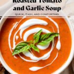 Tomato soup with a drizzle of yogurt in a white bowl garnished with fresh basil leaves.