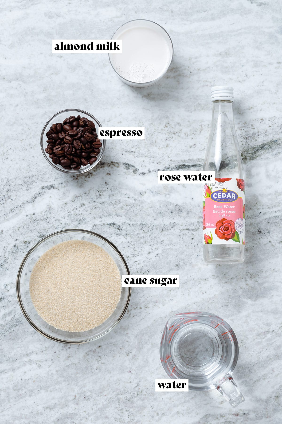 Milk, rose water, coffee beans, cane sugar, and water all measured and laid out with text overlay.