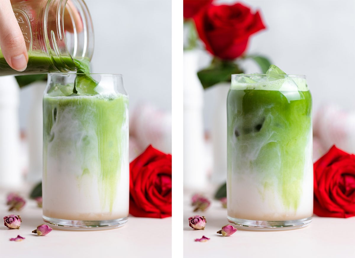 Matcha being poured into a tall glass over milk and ice with red roses around the glass.