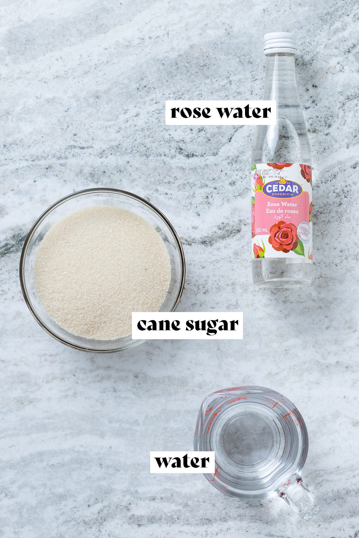 Cane sugar, rose water, and water laid out with text overlay.