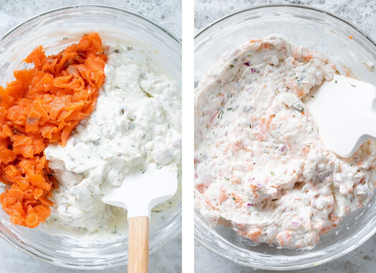 Whipped goat cheese being mixed with chopped smoked salmon.