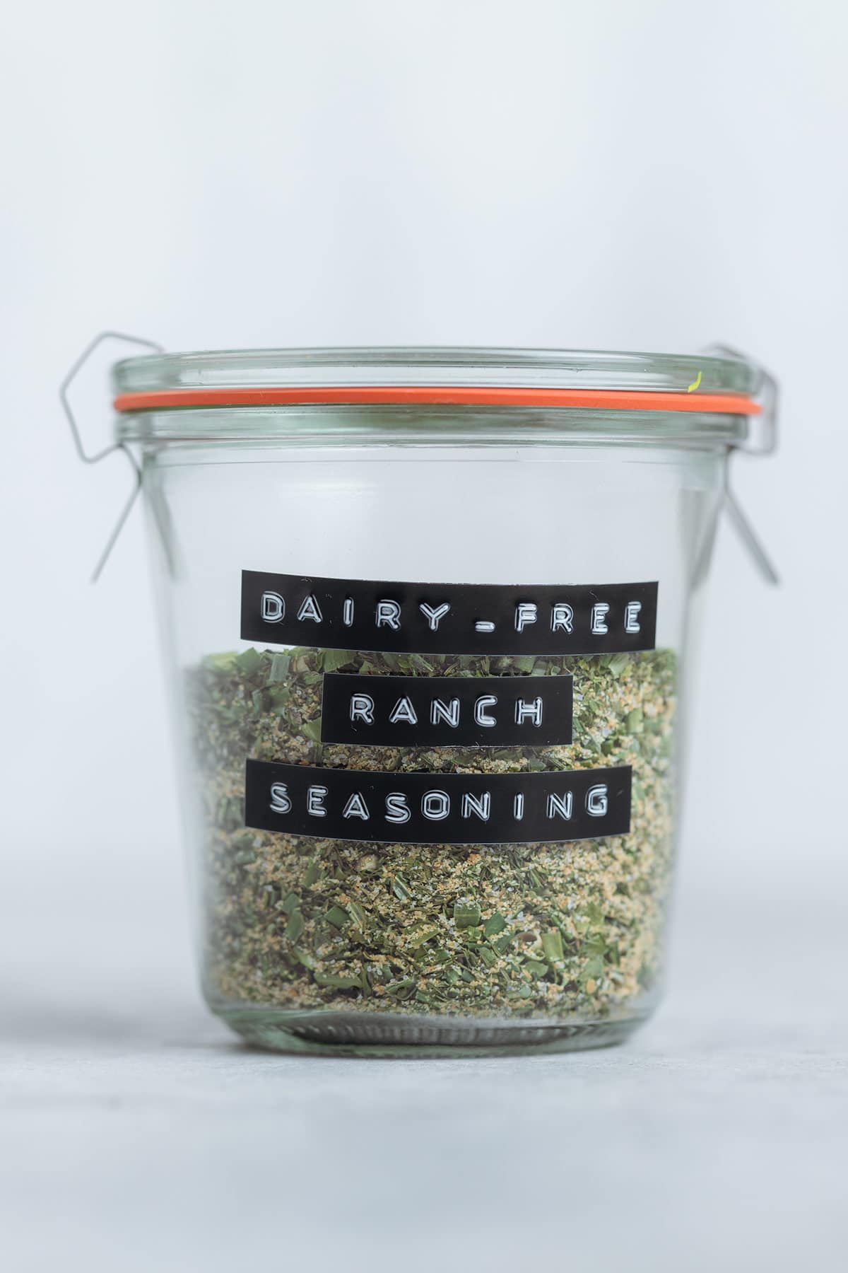 Ranch seasoning in a glass jar labeled with a black label on a white background.