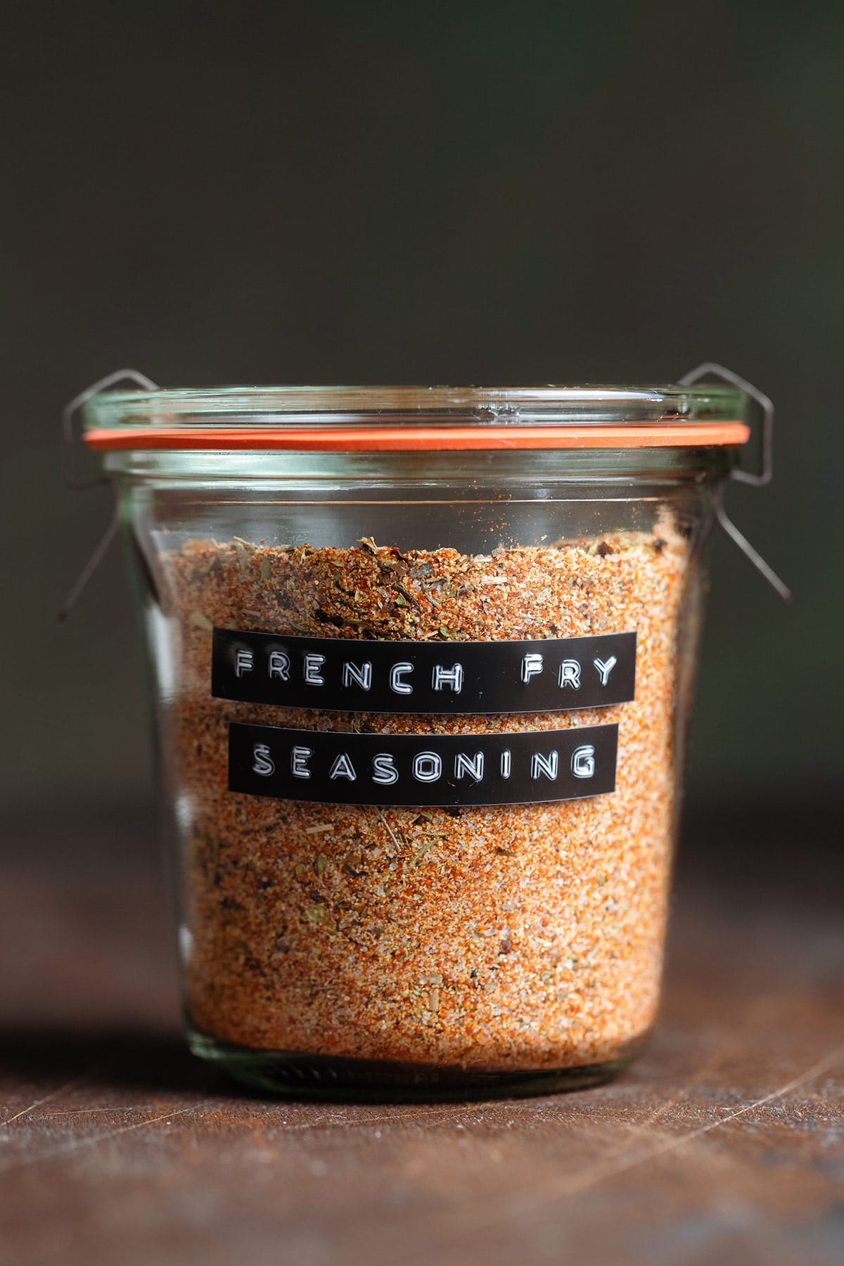 French fry seasoning in a small glass jar with a black label.