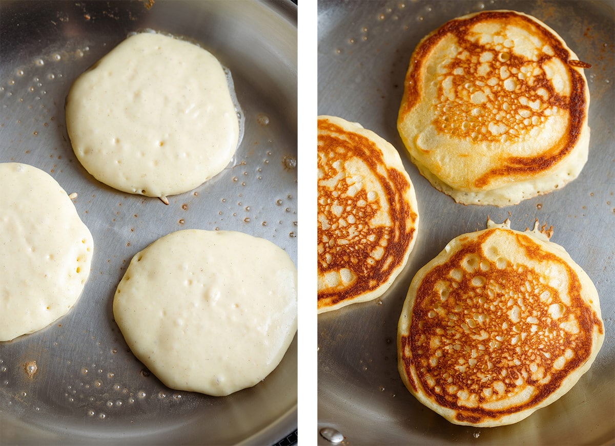 Three pancakes cooking with butter in a large stainless steel pan.