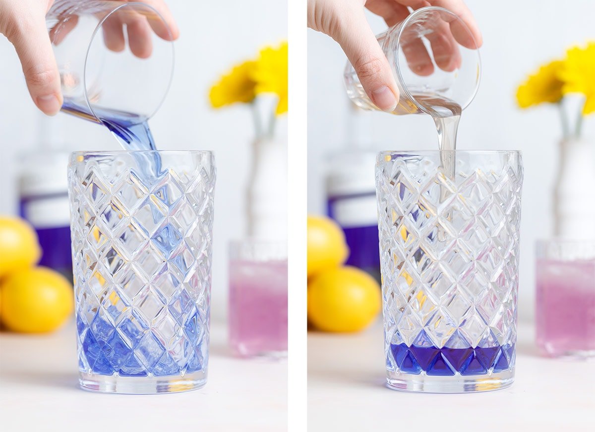 Blue gin and lavender syrup being added into a glass cocktail shaker.