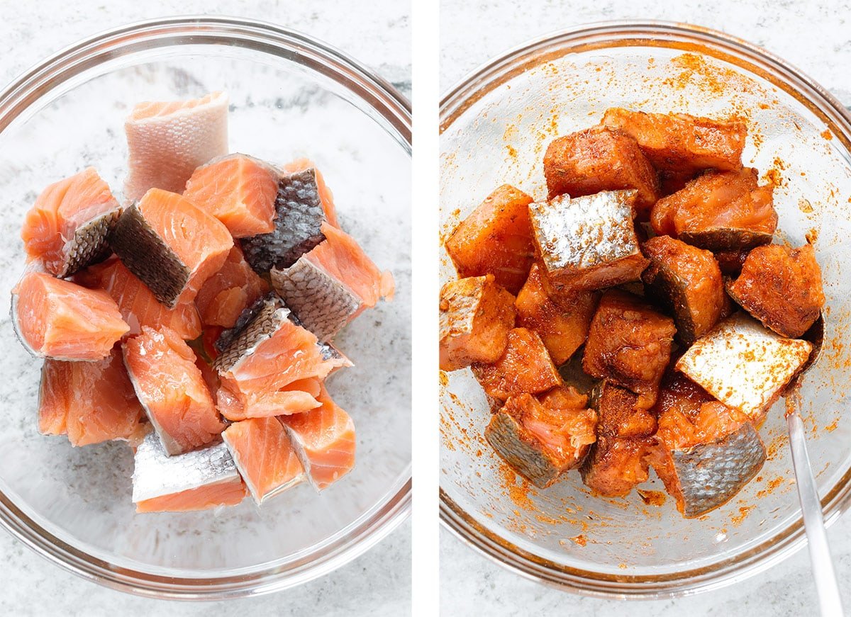 Diced raw salmon in a glass bowl being mixed with cooking oil and spices.