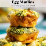 Zucchini egg muffins stacked on top of each other showing the golden crispy sides.