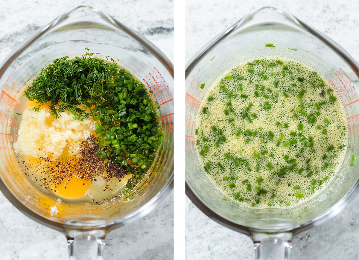 Whisked eggs, herbs, garlic, and spices in a large glass measuring cup.