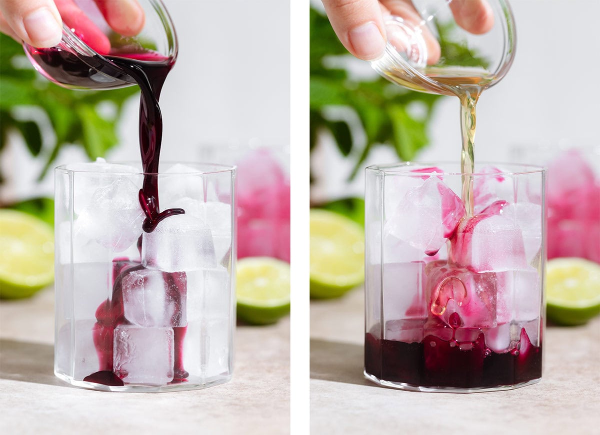 Dark purple blueberry syrup and light yellow mint syrup being added to a short glass filled with ice.