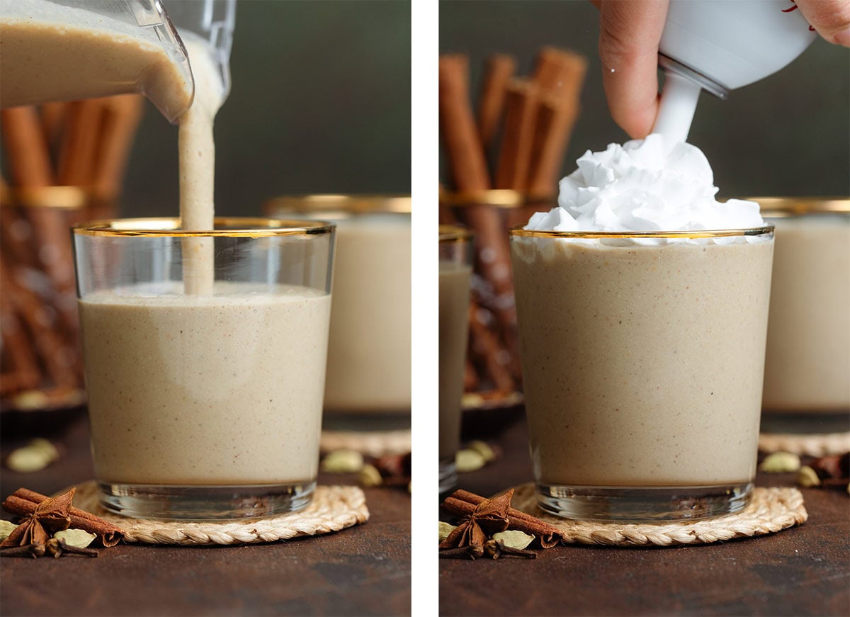 Beige chai smoothie being poured into a short glass with a gold rim and topped with whipped cream.