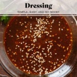 Dark brown miso dressing in a small glass bowl garnished with sesame seeds.