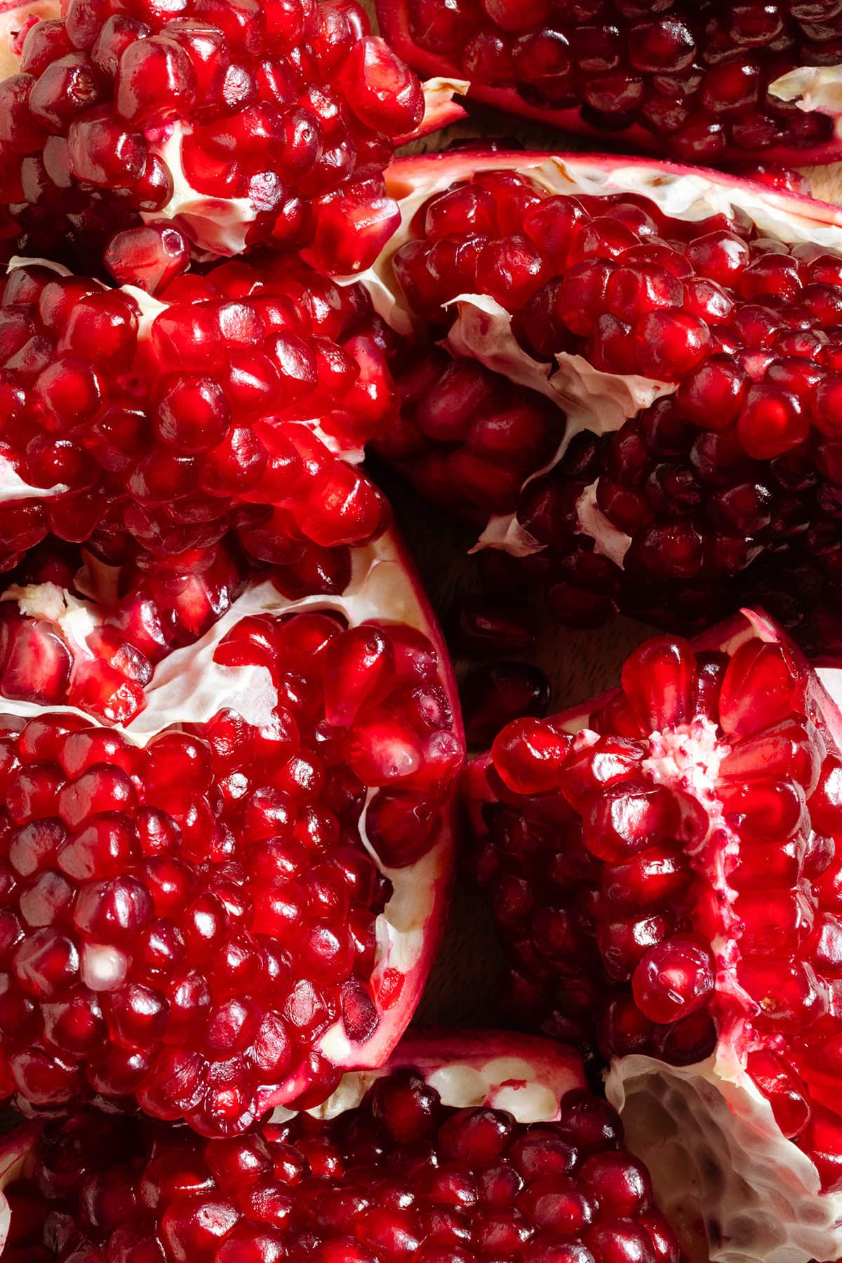 Fresh pomegranate showing all the bright red pomegranate seeds.