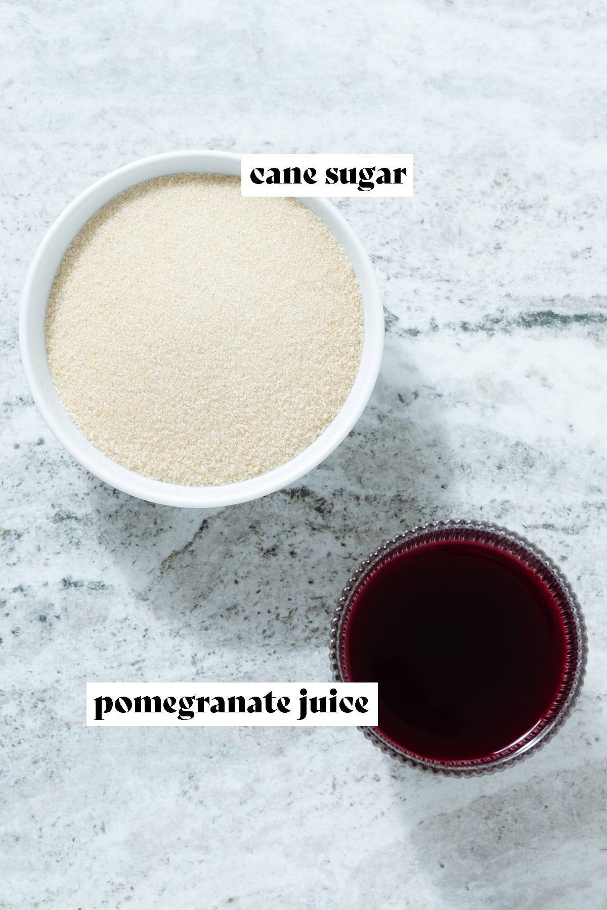 Cane sugar and pomegranate juice in small bowls.