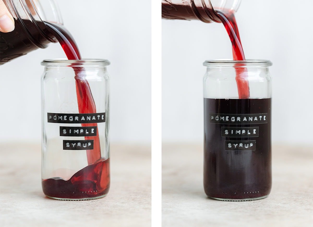 Dark red syrup being poured into a tall glass with an embossed label that says pomegranate simple syrup.