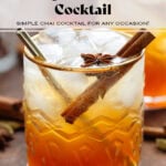 Dark orange cocktail with ice and sparkling water on top for a layered effect in a short glass with a gold rim garnished with a cinnamon stick and star anise.