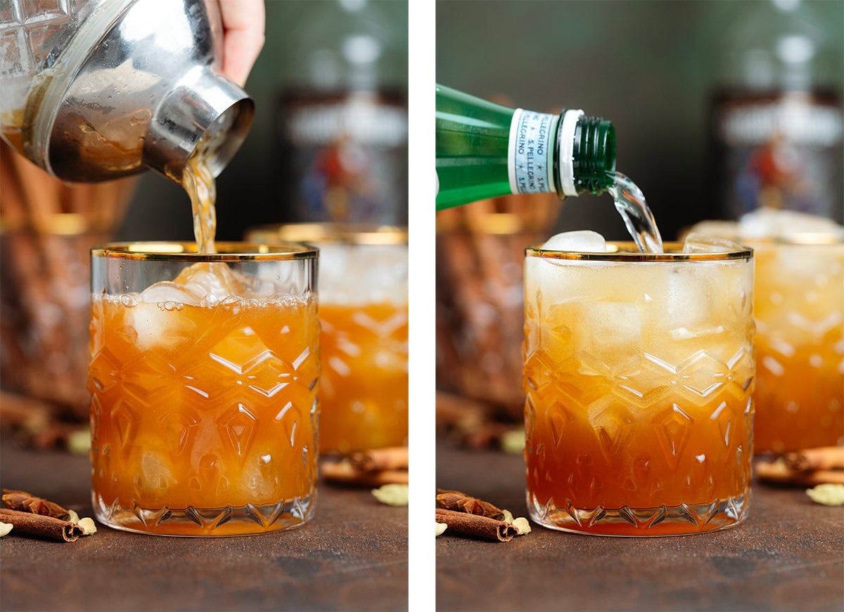 Dark orange cocktail and sparkling water being poured over ice into a short glass with a gold rim.