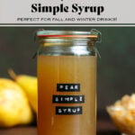 Dark yellow syrup in a glass jar with a lid and a black embossed label that says pear simple syrup on a dark brown background.