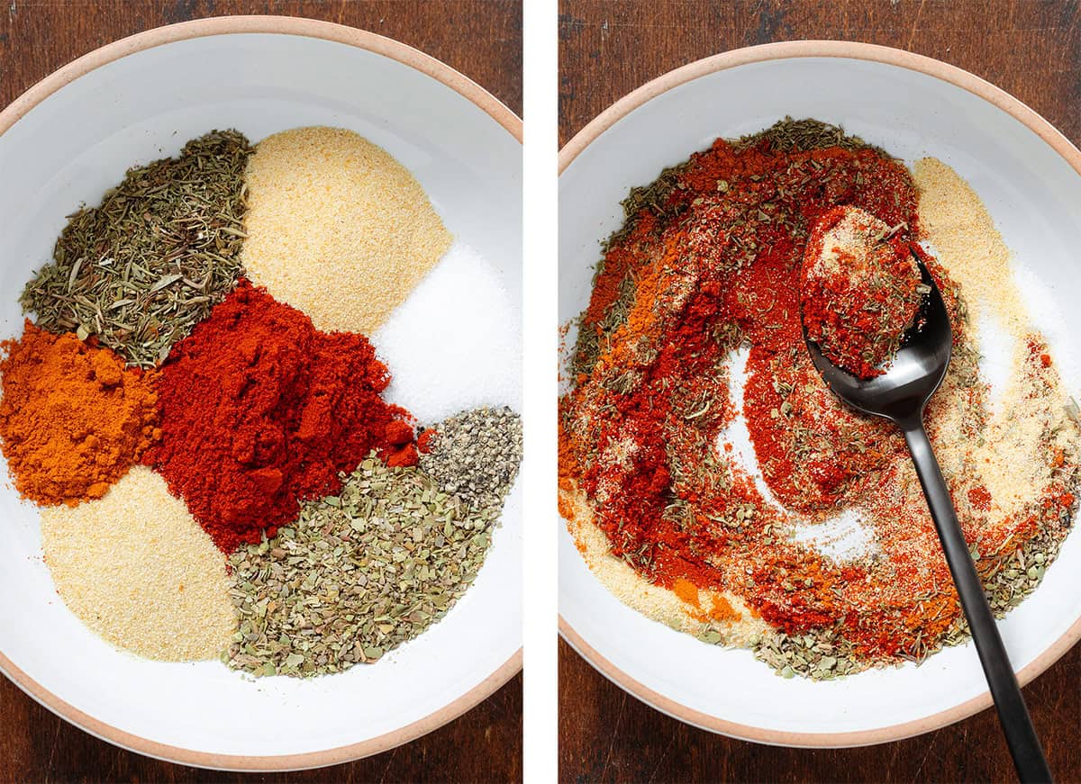 Spices like paprika, oregano, thyme, garlic powder, and sea salt being mixed together in a white bowl with a black spoon.