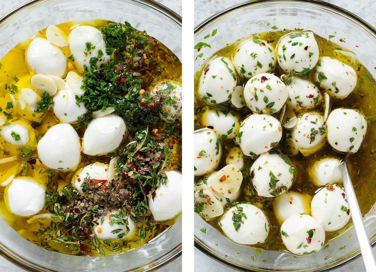 Marinated small mozzarella balls in olive oil and fresh herbs, and sliced garlic in a glass bowl.