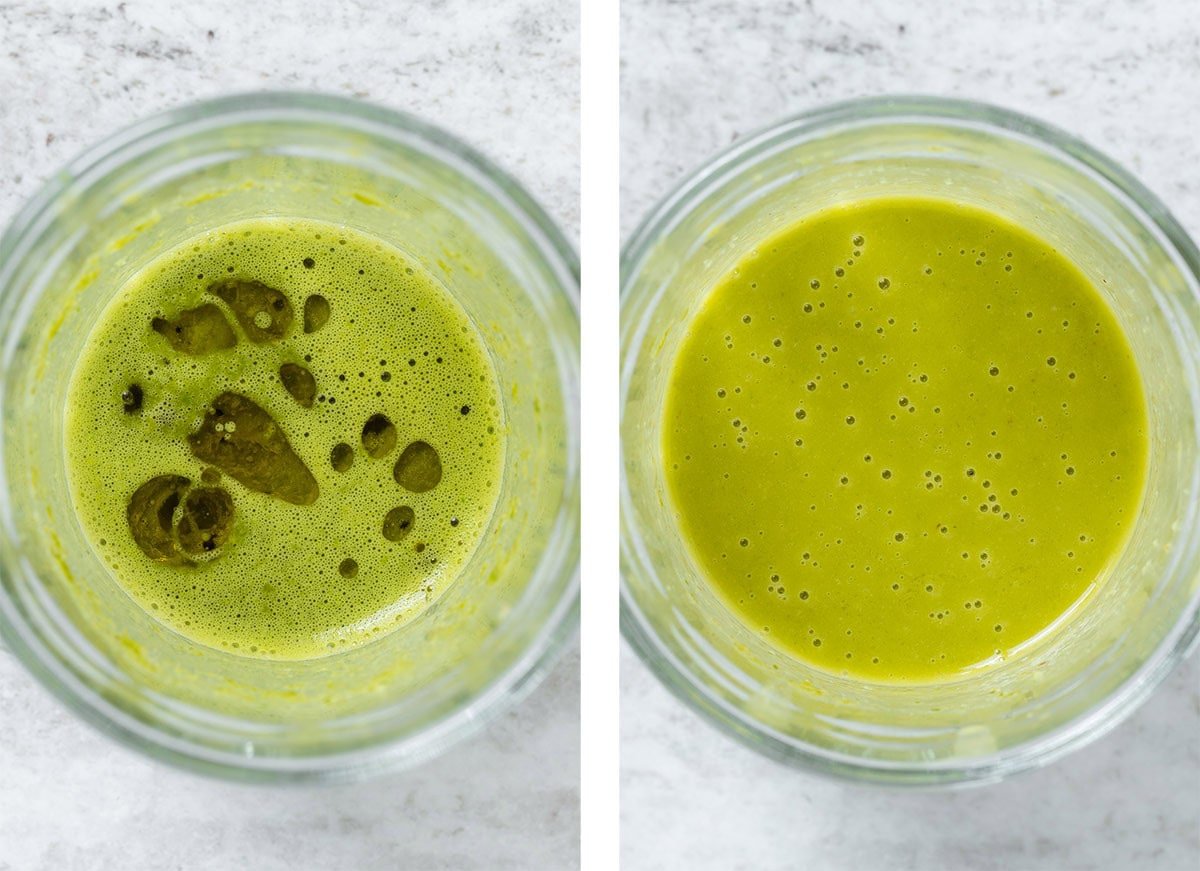 Blended herbs with lemon juice in a glass jar with olive oil being slowly blended in.